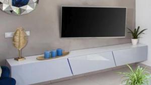 a living room with a television on a white cabinet at Casa Son Juvera Andratx in Andratx