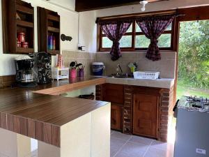 a kitchen with a sink and a counter top at Cabaña 1111 in Valle de Bravo
