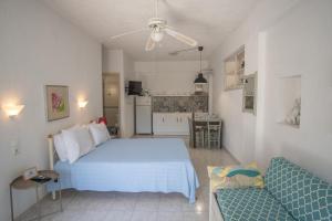 a bedroom with a bed and a couch and a kitchen at Violetta Apartments in Neo Klima