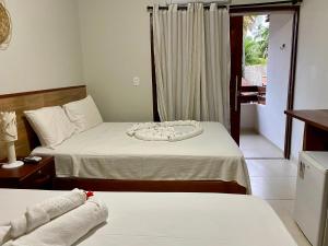 Cama ou camas em um quarto em Pousada Paraíso dos Milagres