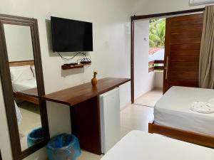 Cama ou camas em um quarto em Pousada Paraíso dos Milagres