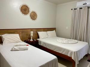 Cama ou camas em um quarto em Pousada Paraíso dos Milagres