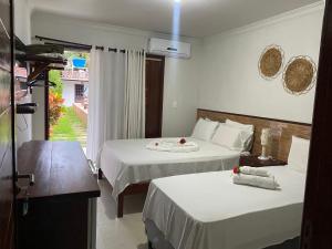 Cama ou camas em um quarto em Pousada Paraíso dos Milagres