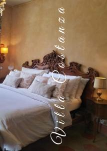 Postel nebo postele na pokoji v ubytování Villa Costanza Appartamento con balcone e vista giardino