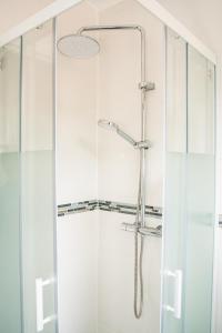 a shower with a glass door in a bathroom at Qhome 1 - Studio entre Paris et Disney in Villiers-sur-Marne