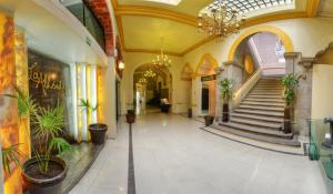 a hallway with potted plants and stairs in a building at Hotel La Alhondiga in Puebla +55 photos