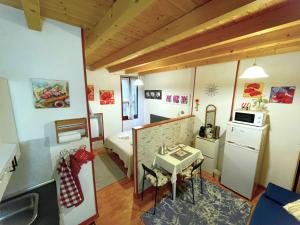 a small room with a small table and a kitchen at A.R.Inter.3 in Brescia