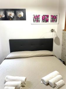 a bedroom with a bed with two towels on it at A.R.Inter.3 in Brescia
