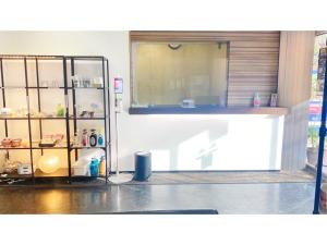 a kitchen with a counter and a glass door at Takatsuki W&M Hotel - Vacation STAY 48549v in Takatuki