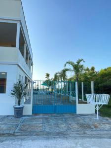 a fence with a bench in front of a building at Voar Pousada in Barreirinhas