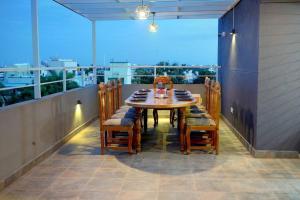 a table and chairs on a balcony with a view at Elite Enclave - Vento - 2BHK Luxury Serviced Apartments in Mysore