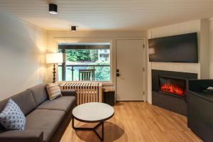 a living room with a couch and a fireplace at Historic Rocky Waters Inn, A Small Luxury Hotel in Gatlinburg