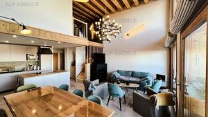 a kitchen and a living room with a table and chairs at Résidence Alpine Loft - 5 Pièces 10 pers- HAUT DE GAMME - ALPINE LOFT - 10ALPI-PLAGNE CENTRE MAE-2634 in Aime La Plagne