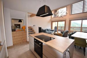 a kitchen and living room with a table and a dining room at Résidence Alpine Loft - 5 Pièces 10 pers- HAUT DE GAMME - ALPINE LOFT - 10ALPI-PLAGNE CENTRE MAE-2634 in Aime La Plagne +14 photos