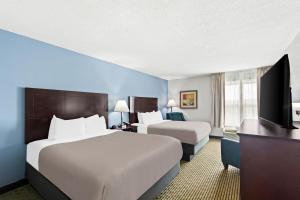 a hotel room with two beds and a flat screen tv at Quality Inn Dry Ridge in Dry Ridge +38 photos