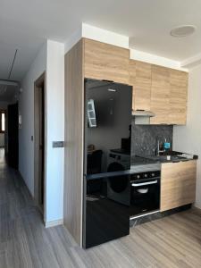 a kitchen with a black refrigerator in a room at Vellosol in Vigo
