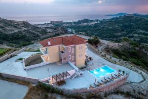 an aerial view of a house with a swimming pool at Agnanti Sea View Villa in Koskinou