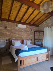 a bedroom with a large bed in a room at POUSADA QUINTAL DAS OLIVEIRAS in Monte Verde +96 photos