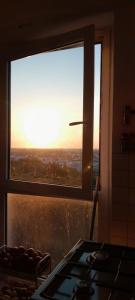 a view of the sunset from a kitchen window at Caen la mer in Caen