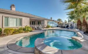 a swimming pool in the backyard of a house at Lux Desert Oasis w saltwater pool near Coachella in Indio
