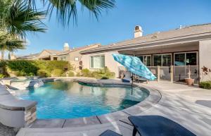 a swimming pool in the backyard of a house at Lux Desert Oasis w saltwater pool near Coachella in Indio