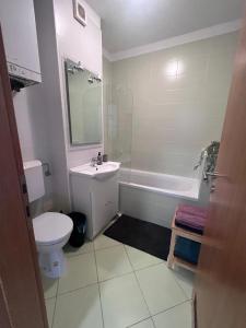 a bathroom with a sink and a toilet and a tub at Studio apartman - Sweet&Little in Vrbovec +7 photos