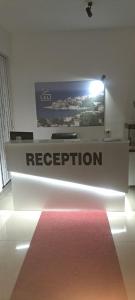 a reception desk with a sign in a room at Leli Apartments in Ulcinj