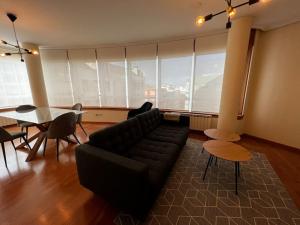 a living room with a couch and a table at Oktheway Marino in A Coruña +38 photos