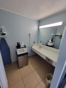 un bagno con lavandino e specchio di Travelodge by Wyndham Clovis a Clovis Altre 29 foto
