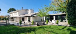 a white house with a lawn in front of it at CasaKadd002LuxuryHeated Pool Garden Patio Barbeque in Civé
