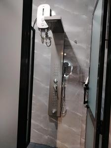 a bathroom stall with a phone and a bike at New city self catering luxury apartment in Bandaragama