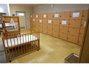 a large room with lockers and a room with a room with at Sunroad Kibiji - Vacation STAY 05992v in Soja