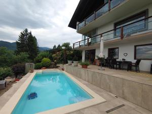 a swimming pool in front of a house at Landhaus Karawankenblick, Saurachberg 42 in Himmelberg