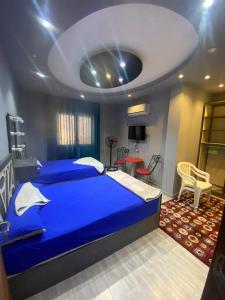 a bedroom with a large blue bed in a room at Villa in Stella Heights - North Coast in El Alamein