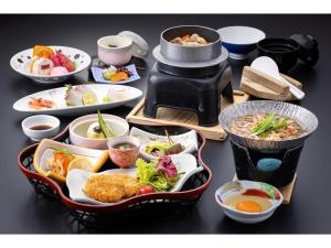 a table with plates of food and bowls of food at Sunroad Kibiji - Vacation STAY 05992v in Soja