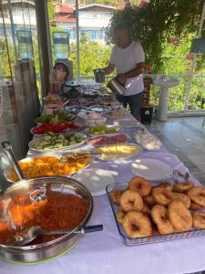 a table with a buffet of food on it at Akdeniz Pansiyon in Ekincik