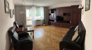 a living room with two chairs and a table at Apartament Gdynia Centrum in Gdynia