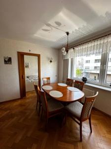 a dining room with a wooden table and chairs at Apartament Gdynia Centrum in Gdynia
