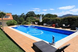 a swimming pool in the backyard of a house at Casa familiar cerca de playa América in Nigrán