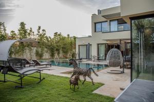 a couple of giraffe statues in front of a house at AD Villa in Marrakesh