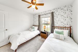 two beds in a room with a window at Lovely San Antonio Vacation Rental with Private Yard in San Antonio +25 photos