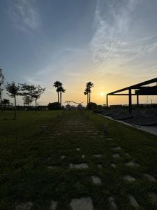 a park with palm trees and a roller coaster at Andrra Apartment - Talea Coast in Lezhë