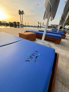 a blue surfboard with the words happy beach on it at Andrra Apartment - Talea Coast in Lezhë