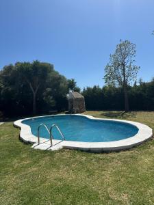 a swimming pool in the middle of a field at Villa Natalia in La Zarzuela