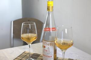 two glasses of white wine next to a bottle of wine at Nirvana Apartment Quiet Stay with Free Parking & Airport Access in Athens +13 photos