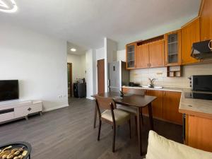 a kitchen with a wooden table and a kitchen with a counter at JO-AL, Delijorgji in Tirana