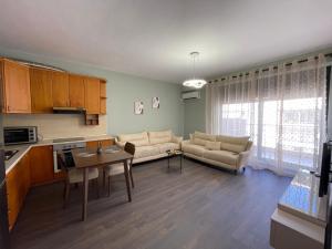 a living room with a couch and a table at JO-AL, Delijorgji in Tirana