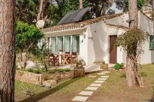 a white house with a picnic table in the yard at Elviria Beachside House Marbella in Marbella