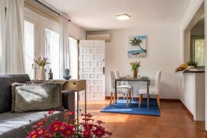 a living room with a couch and a table at Elviria Beachside House Marbella in Marbella