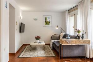 a living room with a couch and a table at Elviria Beachside House Marbella in Marbella